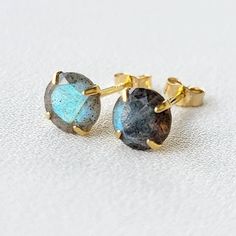 Capture the mystique of the northern lights with our labradorite stud earrings. These earrings showcase the iridescent beauty of labradorite, revealing a play of colors that shifts with the light. Meticulously crafted for a touch of enchantment, these studs effortlessly elevate your style. Embrace the captivating allure of labradorite, a unique and versatile addition to your jewelry collection that adds a touch of magic to any ensemble. Two 6mm labradorite stones in a 14k gold plated solid .925 Labradorite Earrings For Pierced Ears As Gift, Round Labradorite Gemstone Earrings, Adjustable Round Labradorite Earrings, Labradorite Earrings As A Gift, Labradorite Earrings For Gift, Labradorite Earrings Gift, Gemstone Stud Earrings, Gemstone Studs, Labradorite Stone