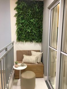 a balcony with plants on the wall and a bench in the corner next to it