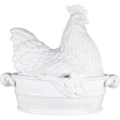 a white ceramic chicken sitting in a bowl