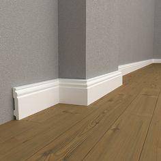 an empty room with wood floors and gray walls