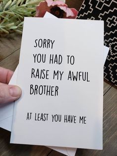 someone holding up a card that says sorry you had to raise my awful brother at least you have me