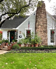 a house with potted plants in front of it