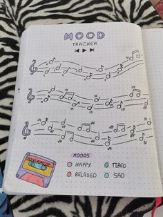 an open notebook with music notes on it