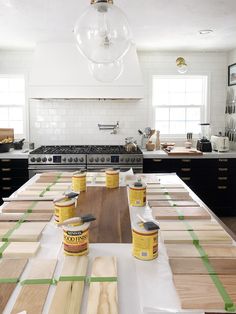 the kitchen counter is covered with paint and wood planks