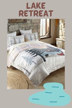 a bed with a comforter and pillows on top of it in a room next to a stone wall