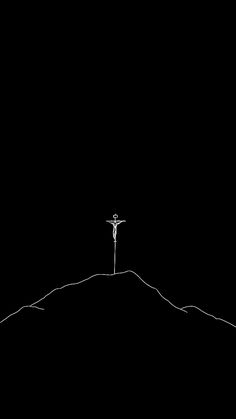 a person standing on top of a hill with a cross