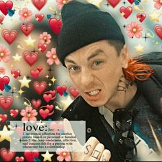 a man with red hair wearing a beanie and pointing at the camera while surrounded by hearts