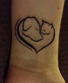 two cats in a heart tattoo on the ankle