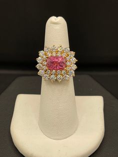 This is a beautiful and very rare Pamir Spinel and Diamond 18K yellow gold statement ring. The Spinel is very rare as it is a single source gem that is only mined for about two months a year due to the climate in the Pamir mountains in Tajikistan, the second highest mountain range in the world. The same company that mines this Spinel, facets it to the highest standards therefore they never have bellys or windows and have the most return of light. This clean cushion cut Spinel has a neon orangy p Luxury Gia Certified Yellow Gold Cluster Ring, Luxury Gia Certified Cluster Ring In Yellow Gold, Exquisite Formal Yellow Gold Cluster Ring, Exquisite Yellow Gold Cluster Ring For Formal Occasions, Dazzling Yellow Gold Sapphire Ring For Formal Occasions, Luxury Gia Certified Yellow Gold Sapphire Ring, Luxury Yellow Gold Gia-certified Sapphire Ring, Gia Certified Oval Gold Sapphire Ring, Fine Jewelry Gold Ruby Ring Gia Certified