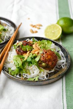 two plates filled with food and chopsticks on a table