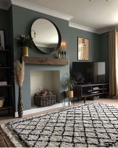 a living room with a fireplace, mirror and rug on the floor in front of it