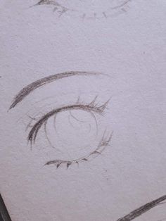 a drawing of an eye with long lashes and eyelashes drawn in pencil on white paper