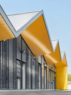 an empty parking lot in front of a building with yellow awnings