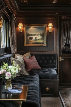 a living room with couches and paintings on the wall