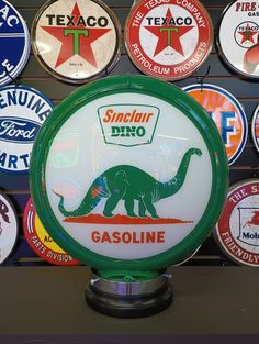 there are many different types of gas signs on the wall in this shop, including one for gasoline and one for texco