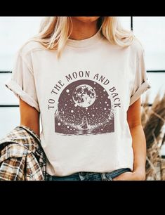 To the moon and back graphic tshirt with moon and fairycore aesthetic. - Gildan t shirt - Classic fit - 100 %cotton - Machine wash and dryer safe - Cold wash inside out, low heat tumble dryer Unisex SIZING Chart: Small:       Length 28" - Width 18"   Medium:  Length 29" - Width 20"   Large:      Length 30" - Width 22"   XL :           Length 31" - Width "24   2XL:          Length 32" - Width 26"   3XL:          Length 33" - Width 28"  All measurements are approximations. Shirts may be within 1" Moon Tshirt, Moon Nature, Mystical Moon, Magic Moon, Fairycore Aesthetic, Moon Shirt, Grunge Fairy, Nature Shirts, To The Moon And Back