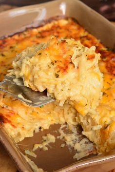 a casserole dish is shown with a fork in it and has cheese on top