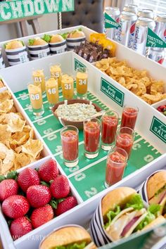 a football party with food and drinks on the sidelines, including sandwiches, chips, salads and dips