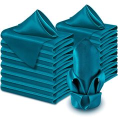 a stack of teal colored napkins sitting on top of each other