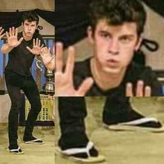 the young man in black shirt is doing tricks on his skateboard and holding his hands up