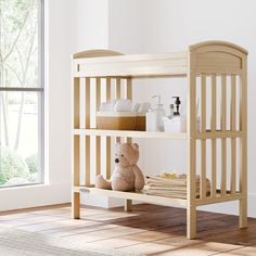 a teddy bear sitting on top of a wooden bunk bed