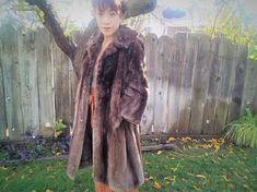 "Luxurious thick and oh so soft vintage 1960's beaver fur coat. This glamorous coat is in mint condition and has the ultimate brown soft and thick shaved undercoat fur. The sleeves are long and wide for plenty for layering. The body is slightly a-line design is flattering without being bulky. Features a folded collar and hidden clasp at the neck and waist. The coat is long and reaches just below the knee. The inner lining is in pristine condition and features gorgeous brocade floral design in el Vintage Beige Long Fur Coat, Vintage Long Beige Fur Coat, Retro Brown Fitted Fur Coat, Beaver Fur Coat, Vintage Brown Fur Coat With Pockets, Brown Luxury Long-sleeve Fur Coat, Bright Stars, Electric Blue, Screw Back Earrings