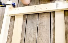 a person is working on some wood planks