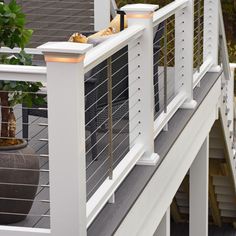 an outdoor deck with railing and planters on it