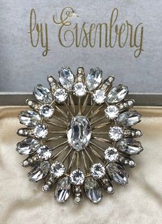 This stunning vintage 1940's Eisenberg fur clip is a must-have for any fashion jewelry collector. The piece is made of sterling silver and features beautiful clear rhinestones in a prong setting. The brooch is signed by the designer multiple times and has a weight of 63g. Length 2 3/4 inches approx Width 2 1/2 inches approx Weight 63g The fur clip is perfect for people who appreciate the classic look of vintage jewelry and the quality cannot be beat. The piece has a timeless appeal and can be wo Vintage Crystal Brooches For Anniversary, Vintage Crystal Brooches For Formal Occasions, Glamorous Formal Jewelry Brooch, Glamorous Formal Jewelry With Brooch, Glamorous Silver Brooch Jewelry, Rhinestone Costume, Fort Wayne, Vintage Rhinestone, Clear Rhinestones