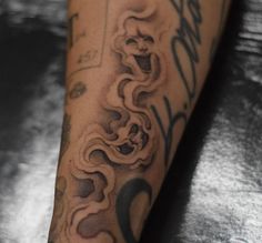 a close up of a person's leg with tattoos on it and writing on the side