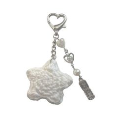 a white keychain with a star shaped object hanging from it's side