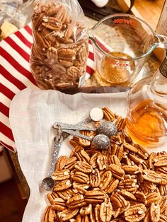 there is a pile of pecans on the table next to some bottles and spoons