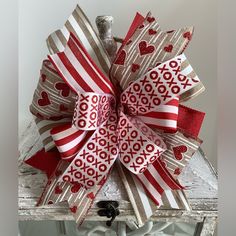 a red and white bow with hearts on it