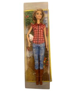 the doll is wearing jeans and a red shirt with plaid on it's chest