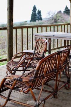 three wicker chairs on a wooden deck