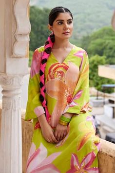 Neon green big floral print asymmetric kurta embellished with sequins. Paired with a striped printed broad pant. - Aza Fashions Green Silk Kurta With Floral Print, Green Silk Kurta For Summer, Green Printed Dresses For Spring, Green Dresses With Printed Motifs For Spring, Green Summer Sets With Printed Motifs, Spring Green Dresses With Printed Motifs, Green Spring Dresses With Printed Motifs, Green Printed Summer Kurta, Spring Green Kurta With Printed Motifs