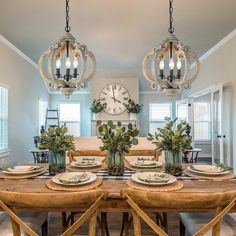 the dining room table is set with plates and place settings for four people to eat