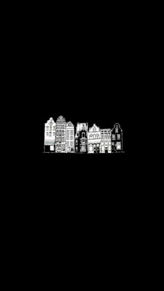 a black and white photo of some buildings in the dark with no people on it