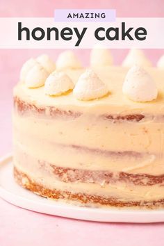 a cake with white frosting and marshmallows on top that says amazing honey cake