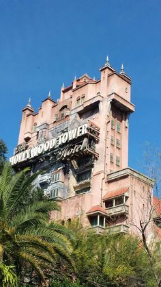 a large pink building with a sign on the top that says hollywood land in front of it