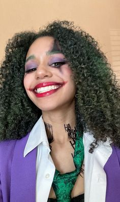 a woman with green hair and makeup wearing a purple jacket, white shirt and tie