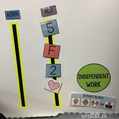 a bulletin board with numbers and stickers on the back wall for students to use