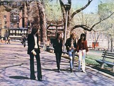 an old photo of some people walking down the street