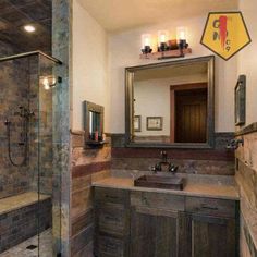 a bathroom with a walk in shower next to a sink and a mirror on the wall