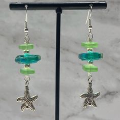 the earrings are made with glass beads and starfish charms