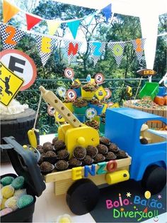 a truck filled with lots of cupcakes sitting on top of a cake table