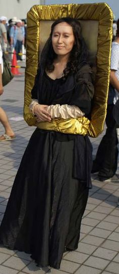 a woman dressed in black and gold carrying a golden object