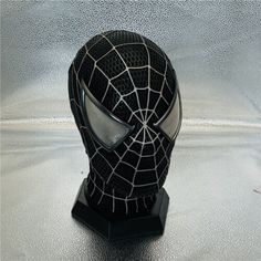 a black spider man mask on top of a table