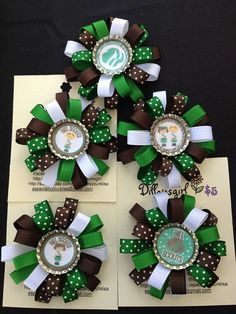 three green and brown hair bows with the letter s on them