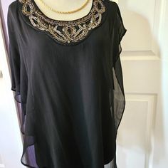 Nwt Beautiful Black Asymmetrical Cape Overlay Blouse With Beaded Neckline. Handwash/ Line Dry Size Large. See Photos For Exact Measurements Jewelry Not Included. Chic Black Embellished Blouse, Chic Beaded Blouse For Party, Elegant Beaded Tops For Night Out, Black Elegant Embellished Blouse, Embellished Evening Blouse For Summer, Elegant Beaded Black Tops, Elegant Black Beaded Top, Black Embellished Blouse For Night Out, Chic Beaded Tops For Evening